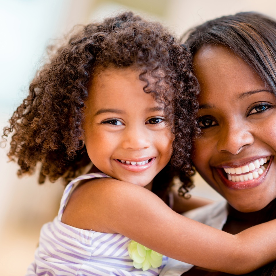 Happy portrait of a mother and daughter smiling