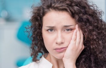 Portrait of a young woman suffering from toothache