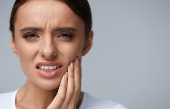 Teeth Problem. Woman Feeling Tooth Pain. Closeup Of Beautiful Sad Girl Suffering From Strong Tooth Pain. Attractive Female Feeling Painful Toothache. Dental Health And Care Concept. High Resolution