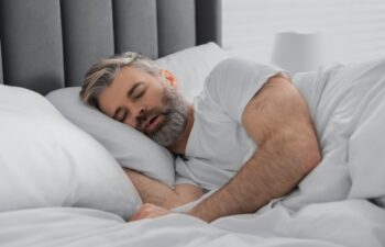 Man snoring while sleeping in bed at home